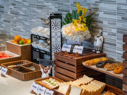a buffet with bread and other foods on a table at Lavande Hotel Chengdu Tianfu Square in Chengdu