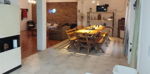 a dining table and chairs in a living room at CasaClubDescanso in General Rodríguez