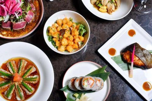 a table with several plates of food on it at Nobu Hotel Toronto in Toronto
