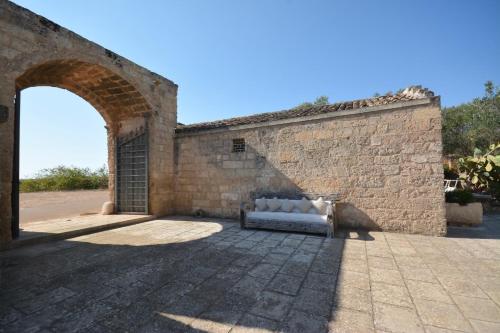 kanapę siedzącą w środku muru. w obiekcie Masseria Bernardini by Symphonya Luxury Rentals w mieście Nardò