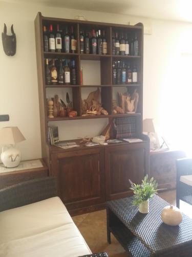 a room with a shelf with various items on it at Hotel Plammas in Santa Maria Navarrese