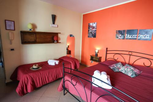 two beds in a room with red walls at Antica Dimora in Palermo