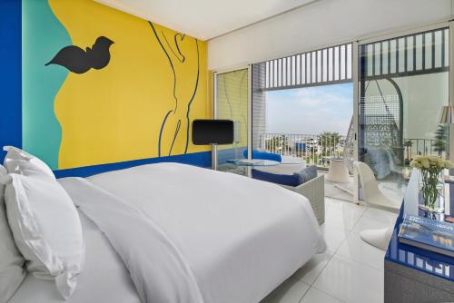 a bedroom with a large bed and a balcony at Sofitel Tamuda Bay Beach And Spa in M'diq