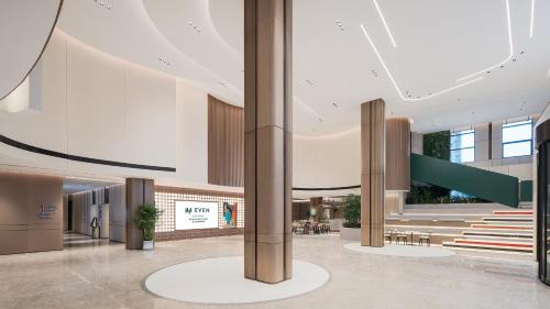 a view of the lobby of a building at EVEN Hotel Wuhan Airport Zone by IHG in Wuhan