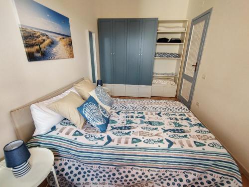 a small bedroom with a bed and a closet at Enjoy The Sea in Calasetta