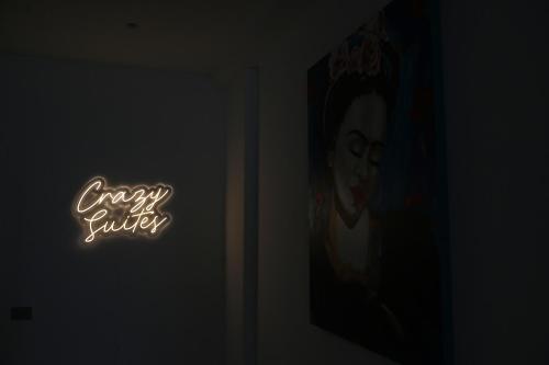 a sign in a dark room with a picture of a woman at Crazi Suites in Nola