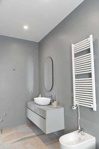 a bathroom with a sink and a mirror at Crazi Suites in Nola