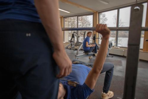 a group of people in a gym lifting weights at Amenity Hotel & Resort Lipno in Lipno nad Vltavou