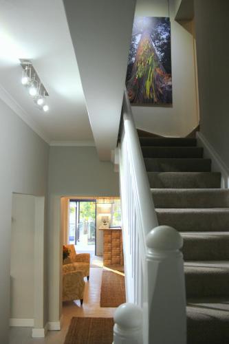 a staircase in a house with a painting on the wall at Lodge on Main Guest House and Conference Centre in Port Elizabeth