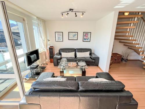 a living room with a couch and a tv at Apartment Schwarzwaldblick IV by Interhome in Bernau im Schwarzwald