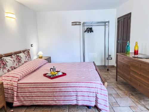 a bedroom with a bed with a tray of fruit on it at Holiday Home Ca' da Ciassa - VLO130 by Interhome in Valloria