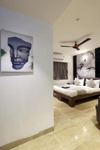 a bedroom with a bed and a ceiling fan at MyOtel - Santacruz in Mumbai
