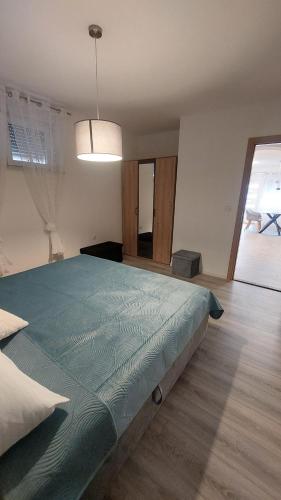 a bedroom with a large bed in a room at Apartment Modrić Zadar II in Zadar