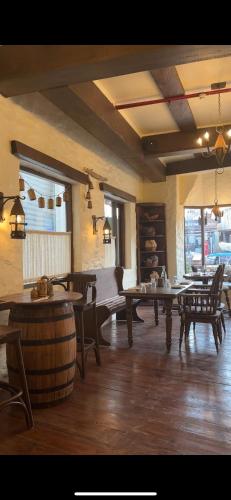 a large room with tables and chairs and a barrel at Hotel Atulyaa Taj in Agra