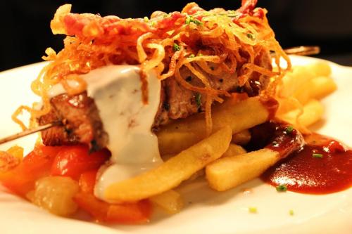 a plate of food with pasta and meat and sauce at Hotel & Residence Hochriegel in Spiegelau