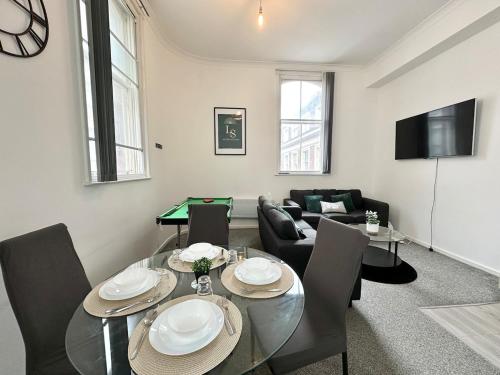 a living room with a dining room table with chairs and a table at City Haven - 2 Bed in Sheffield - LuxeSuites in Midland