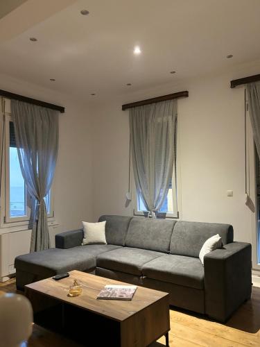 a living room with a couch and a table at Villa Rosa in Plomarion