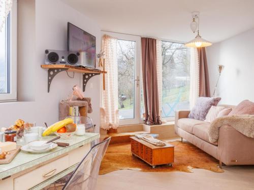 a living room with a couch and a table at Apartment Lau'tentik by Interhome in Monthey