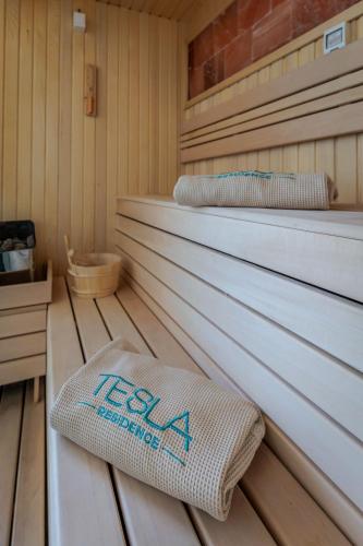 a sauna with two towels on a wooden floor at TESLA Residence Subotica in Subotica