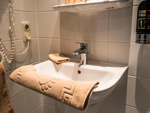 a bathroom with a sink and a faucet at Wetzlarer Hof Hotel & Restaurant in Wetzlar