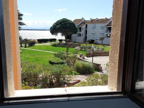 - une fenêtre offrant une vue sur le jardin depuis un bâtiment dans l'établissement Apartment Dominica-4 by Interhome, au Barcarès