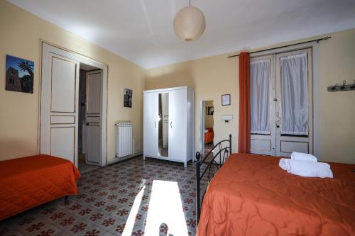 a bedroom with two beds in a room at Antica Dimora in Palermo