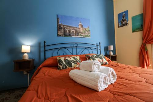 a bedroom with a bed with two towels on it at Antica Dimora in Palermo