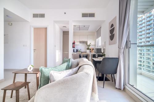 a living room with a couch and a table at Stella Stays Lana Tower in Dubai