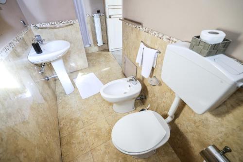 a bathroom with a white toilet and a sink at Antica Dimora in Palermo
