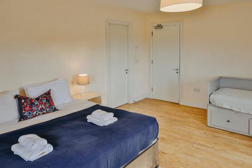 a bedroom with a bed with towels on it at Rock Farm Slane - Limehouse in Slane