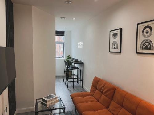 a living room with a couch and a table at Modern Cozy City Centre Double Suite - Fast WiFi, Free Gym Access in Leicester