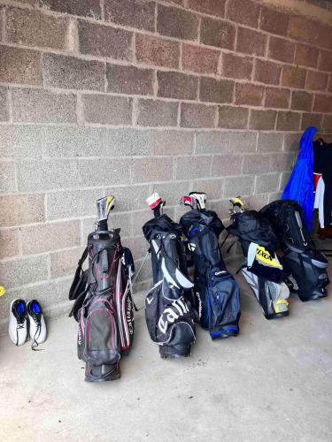 a group of backpacks are lined up against a brick wall at Saintfield Centre - Sleeps 8 - Garage & patio in Saintfield