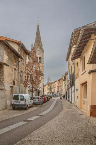 a city street with a clock tower and cars parked at T2 centre de la Verpillière in La Verpillière