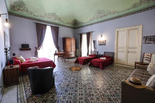 a living room with two beds and a couch at Antica Dimora in Palermo