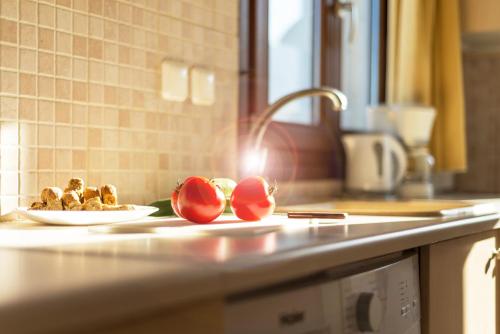 a kitchen counter with a sink and a plate of food at Crete Essence Villas - Lagkada in Makry Gialos
