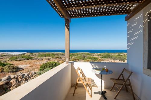 a view of the ocean from the balcony of a house at Crete Essence Villas - Lagkada in Makry Gialos