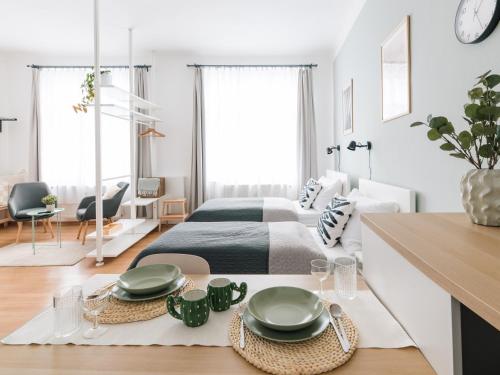 a bedroom with a bed and a table with plates on it at 7nights Apartments Dominikánské naměstí in Brno