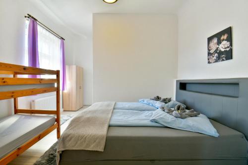 a bedroom with a bed and a window and a ladder at Parkvilla Köhler in Zella-Mehlis