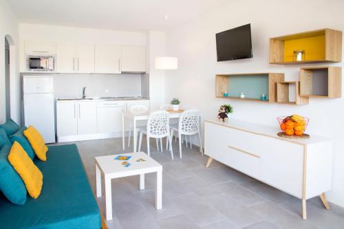 a kitchen and living room with a couch and a table at RVApartaments Estartit Confort in L'Estartit