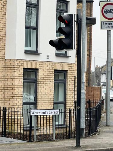 a traffic light in front of a building at Fun 7 holidays entire flat in Huntingdon