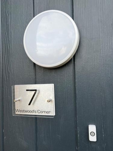 a sign on a wooden door with the number seven at Fun 7 holidays entire flat in Huntingdon