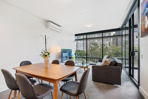 a dining room with a table and chairs at 47OP Elegant Parkview Abnb-Style 2BR Retreat with Free Parking in Sydney