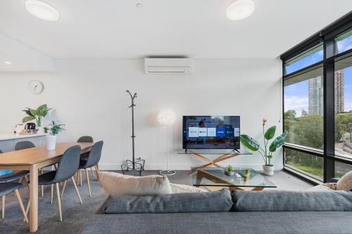 a living room with a couch and a table at 47OP Elegant Parkview Abnb-Style 2BR Retreat with Free Parking in Sydney