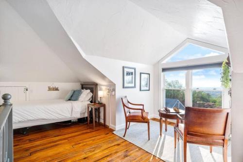 a bedroom with a bed and a table and chairs at Zen Mountainside Retreat - Spa & Amazing Views! Hot tub, Fire pit & Decks in Hagerstown