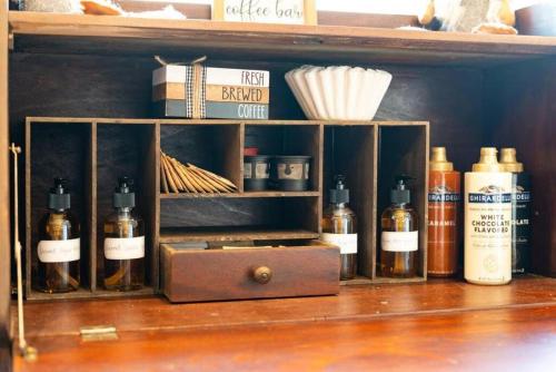 a shelf with a bunch of bottles on it at Zen Mountainside Retreat - Spa & Amazing Views! Hot tub, Fire pit & Decks in Hagerstown