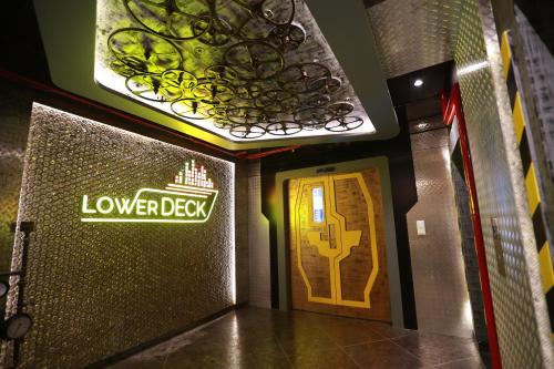 a hallway with a door and a sign that reads lower deck at Hotel Park Elanza Chennai in Chennai
