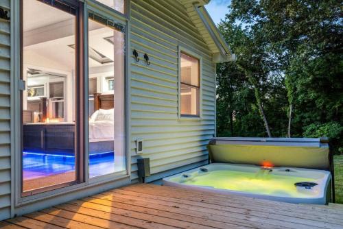 a jacuzzi tub on a porch of a house at Zen Mountainside Retreat - Spa & Amazing Views! Hot tub, Fire pit & Decks in Hagerstown