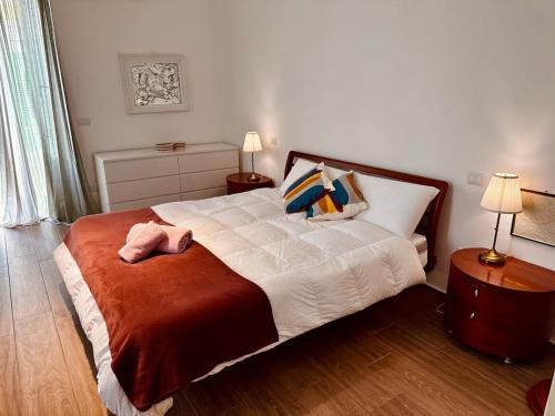 a bedroom with a bed with a pink towel on it at Appartamento nel Cuore di Molfetta in Molfetta