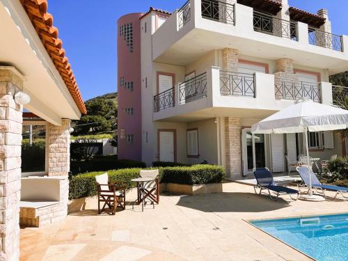 a villa with a swimming pool and a house at Bella Vista pool Villas in Anavissos in Barbaliáki