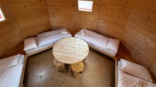 an overhead view of a room with a table and two beds at Hotel Residence Bellavista - Camping Polsa in Brentonico